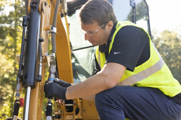 A Cat Hydraulic Repair Technician fixing a heavy machinery issue